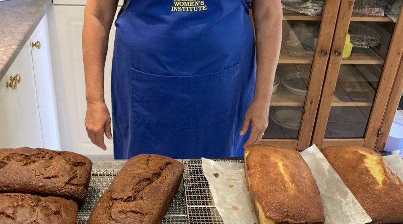 A woman poses in front of lemon loaf.
