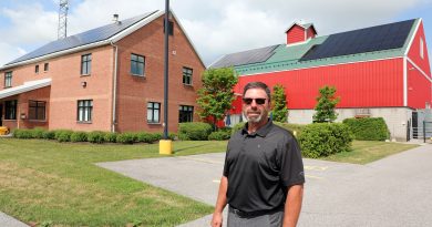A man poses outside a building.