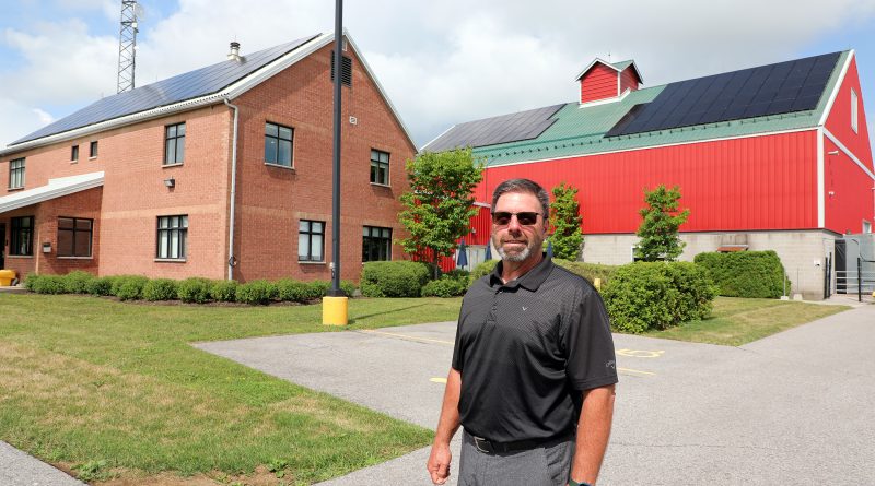 A man poses outside a building.