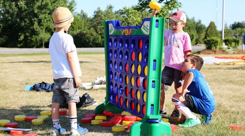 A photo of kids playing connect four.