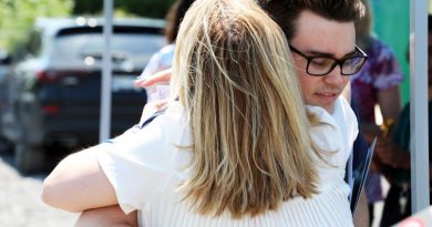 A photo of people hugging.
