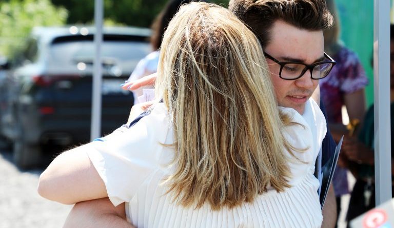 A photo of people hugging.
