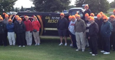 A group of employees pose for a photo.