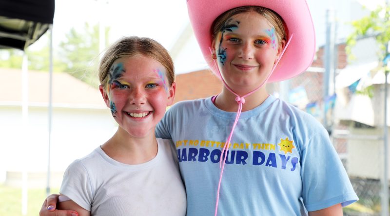 Two kids pose for a photo.