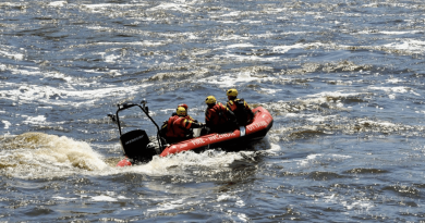 A photo of firefighters on a boat.