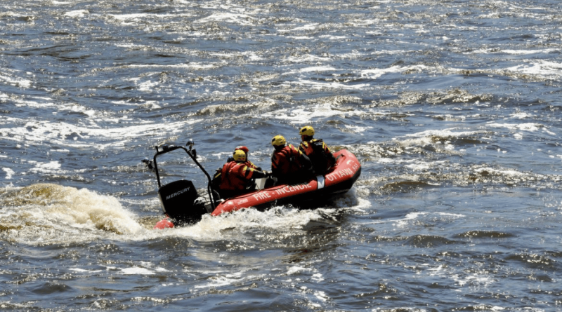 A photo of firefighters on a boat.