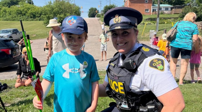 A photo of a young angler and a police.
