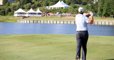 A golfer watches his shot.