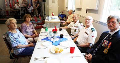 A group of veterans pose for a photo.
