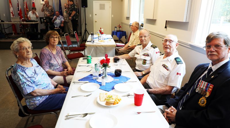 A group of veterans pose for a photo.