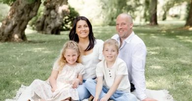 A family of four poses for a photo.
