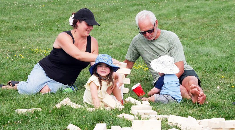 A family plays in a park.