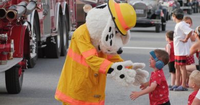 Sparky the Fire Dog greets parade watchers.