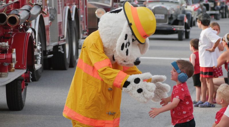 Sparky the Fire Dog greets parade watchers.