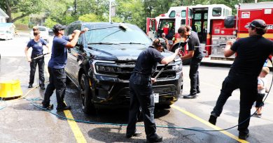 Firefighters wash a car.