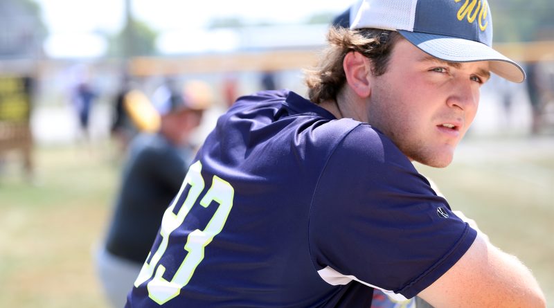 A ball player watches a game.