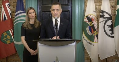 A mayor stands at a podium.
