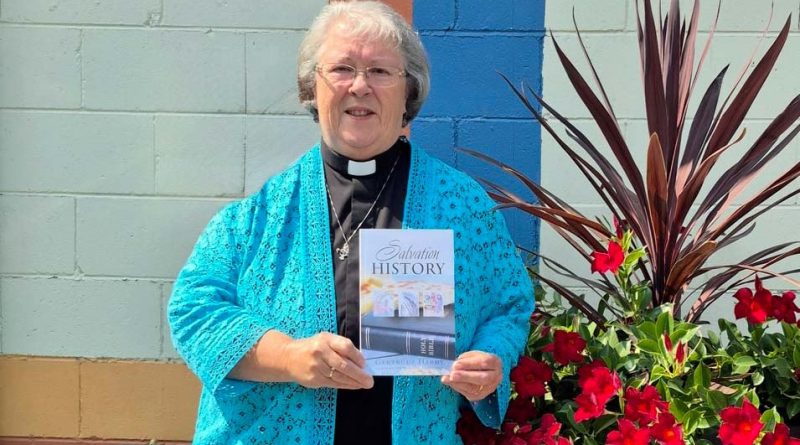 A reverend holds her book.