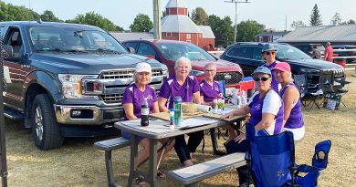 A group enjoy bingo outdoors.
