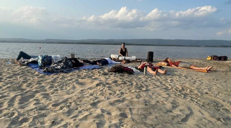 People excercise on the beach.
