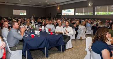 A photo of a room full of people.