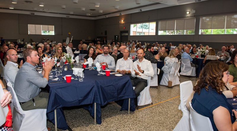 A photo of a room full of people.
