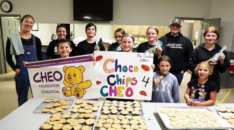 A group poses with cookies.