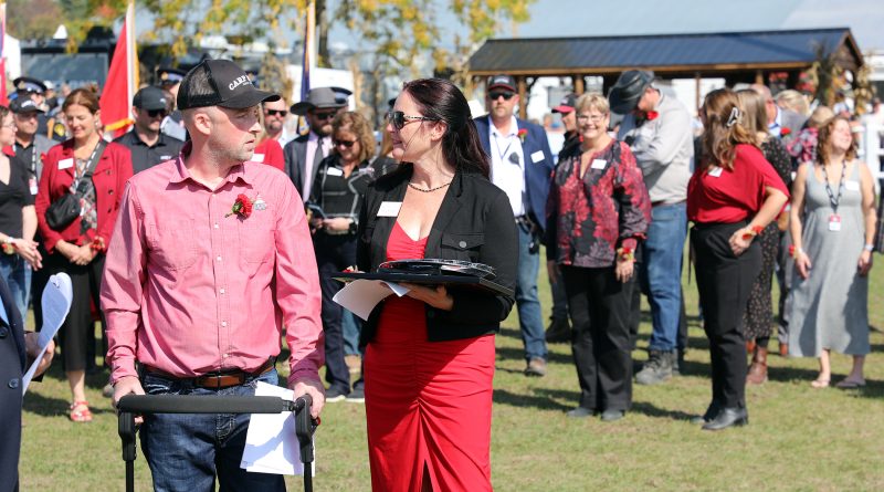 Two people give speeches at a fair opening.