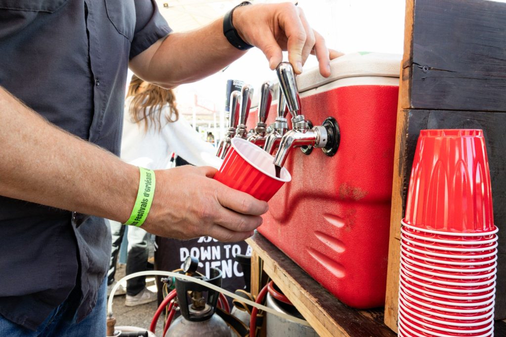 A person pours a beer.