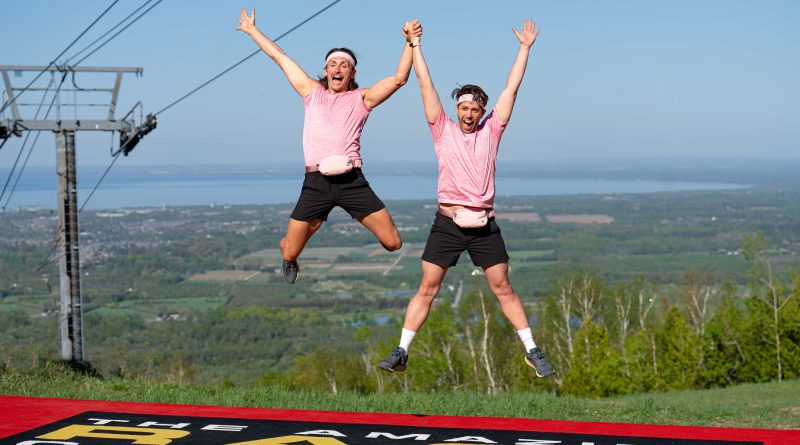 Two people jump with joy.