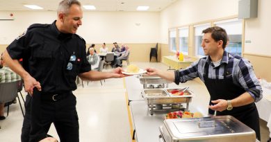 A person serves corn.