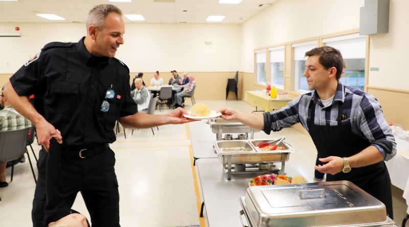 A person serves corn.
