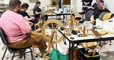 A photo of a team weaving a shawl.