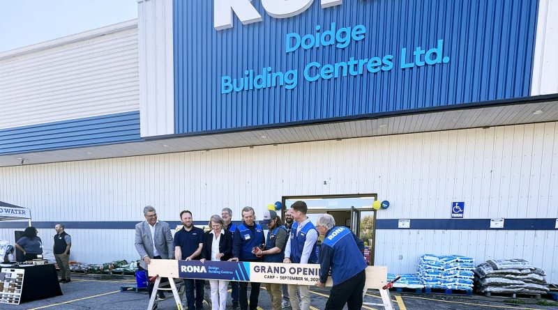 A group photo at a grand opening.
