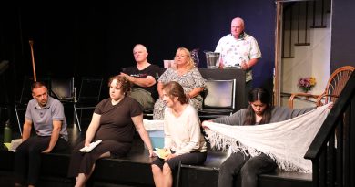 A group of people sit on a stage.