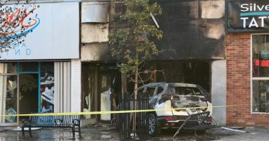 A photo of a car crashed in to a store.