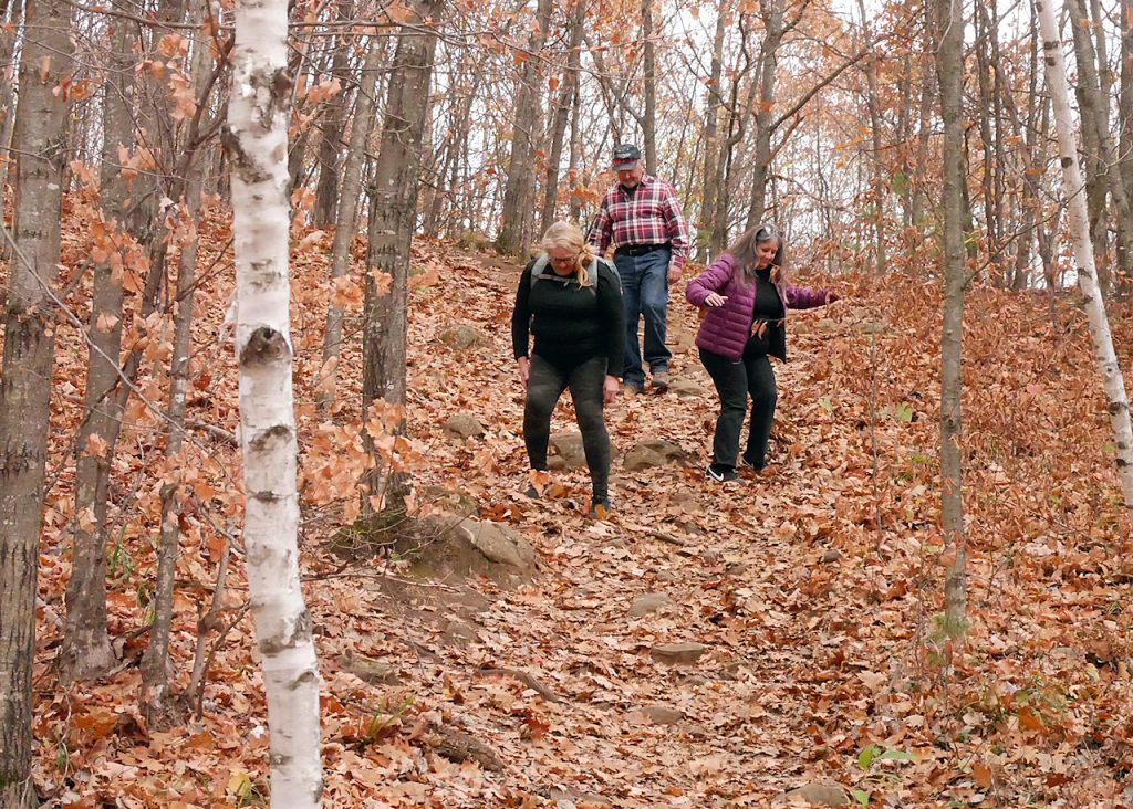 People walk down a trail.