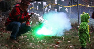 C Bay kids take spooky forest stroll Two people in costumes chat.