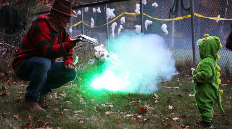 Two people in costumes chat.