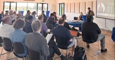 People listen in at a meeting.