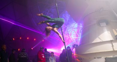 A gymnast performs in an observatory.