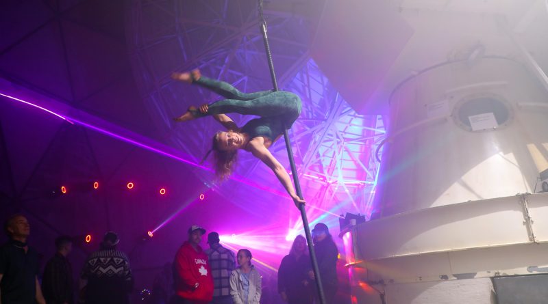 A gymnast performs in an observatory.
