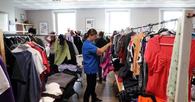 A volunteer sorts clothing.