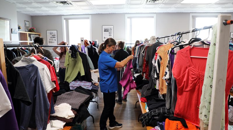 A volunteer sorts clothing.