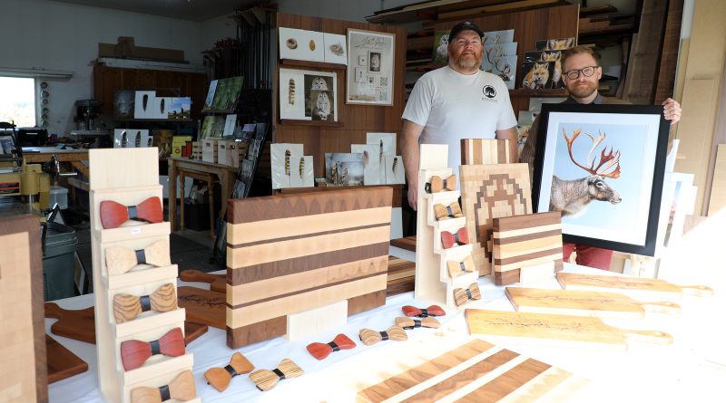 Two people pose with their art.