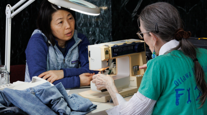 A photo of a woman sewing.