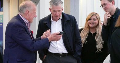 People look at a phone.