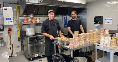 A photo of two cooks in a kitchen.