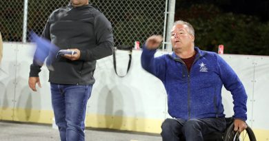 A photo of a person playing cornhole.