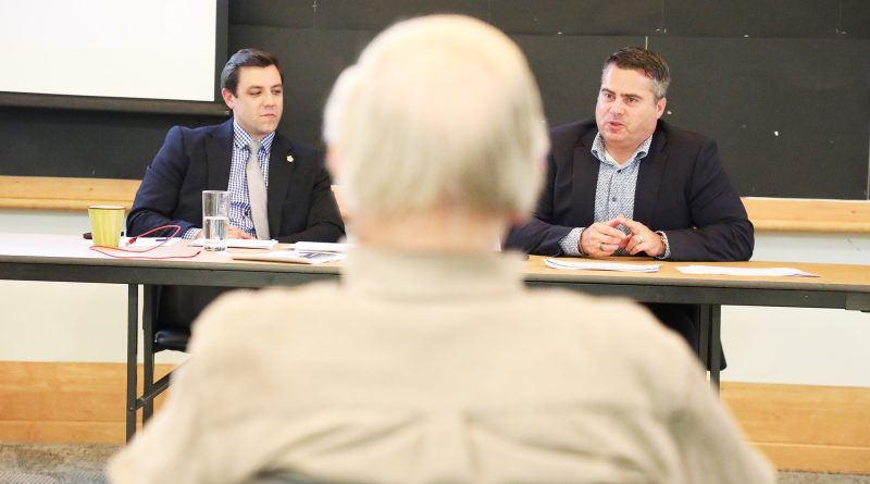 Two people speak in a room.